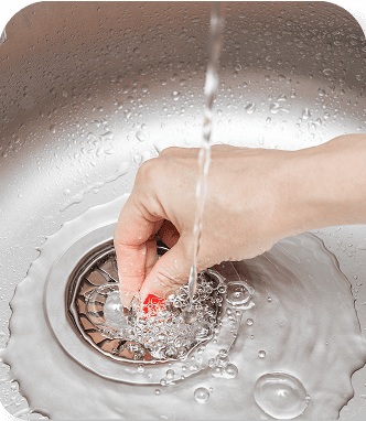 Water flowing into a stainless steel sink drain