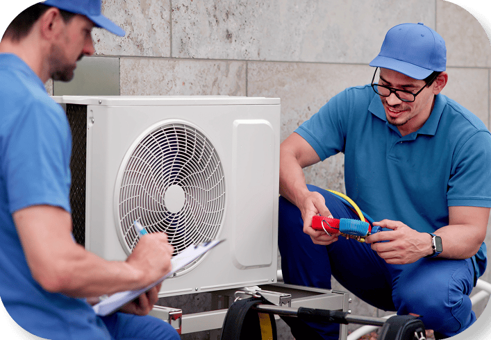 Two HVAC Technicians checking outdoor unit