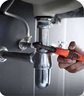 Plumber working under a sink