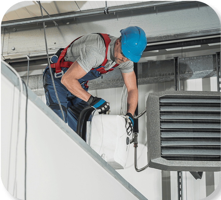 HVAC Technician working in an attic